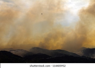 Wildfire Burns The Colorado Mountains With A Plane Above