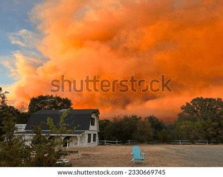 Wildfire clouds over a farm house in the Yosemite Valley, California