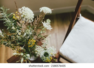 Wildflowers Bouquet And Wooden Chair In Rustic Room. Summertime In Countryside. Home Simple Eco Decor