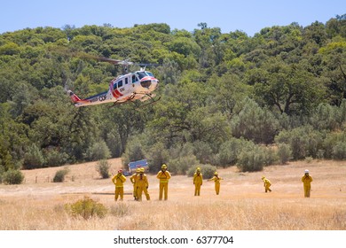 A Wildland Fire Crew Works With A Helicopter