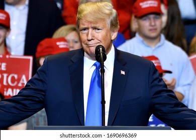 WILKES-BARRE, PA - AUGUST 2, 2018: Donald Trump President of the United States gestures somewhere between a smirk and a smile at a campaign rally.