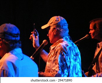 WILKESBORO, NC - AUG 14: Bruce Johnston, Mike Love (with Cell Phone) And Scott Totten Of The Beach Boys Band Perform Onstage At Doc Watson Theatre In Wilkesboro, NC  August 14, 2008.