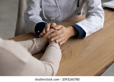It will be all right. Close up view of female doctor gp hands hold caress palms of woman patient. Young lady general practitioner therapist physician comfort sick person give hope support care belief - Shutterstock ID 2093260780