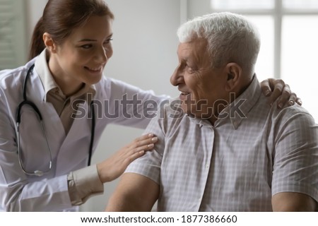It will be all right. Friendly female doctor support encourage mature grey haired male patient. Caring young woman physician share optimism with sick old man ensure in favorable prognosis for disease Stock photo © 