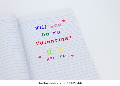 Will You Be My Valentine Text In Open Lined Notebook Isolated On White Background.Selective Focus,easy To Use For Card. Minimal Love Concept.Copy Space For Text.