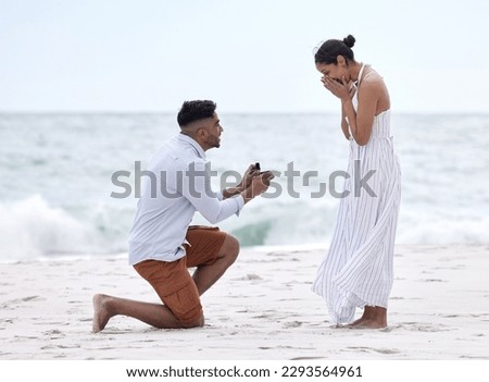 Will you marry me. Full length shot of a handsome young man proposing to his girlfriend on the beach. Foto stock © 
