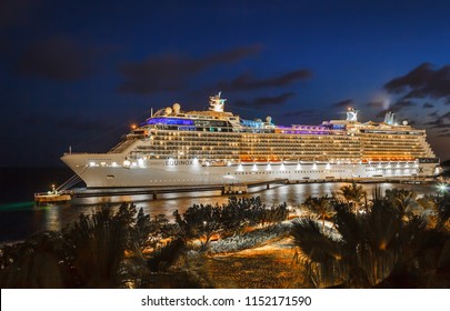 WILLEMSTAD, CURACAO - APRIL 11, 2018: Cruise ship Celebrity Equinox docked at night in port Willemstad. The island is a popular Caribbean cruise destination