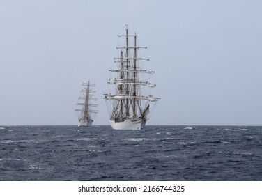 Willemstad, Curacao - June 12, 2022: Cisne Branco followed by ARM Cuauhtémoc running rigging preparing to hoist sails during; sail away the Velas Latinoamérica Curaçao 2022 festival in Curacao