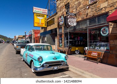 Williams, Arizona, USA: May 24, 2019: Street scene with classic car in front of souvenir shops in Williams, one of the cities on the famous route 66
