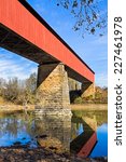 The Williams Covered Bridge spans the East Fork of the White River in rural Lawrence County, Indiana. The two span Howe truss design, built in 1884, is 373 feet long.