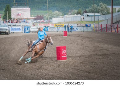 Williams Lake, British Columbia/Canada - June 30, 2016: a barrel racer swerves around the second barrel at the 90th Williams Lake Stampede, one of the largest stampedes in North America