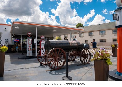 Williams, USA. September 16, 2022. Tourist Photographing Old Gas Station. Male Traveler Is Standing By Rustic Fuel Wagon On Road. He Is Having Fun At Route 66 In City Of Williams During Summer.