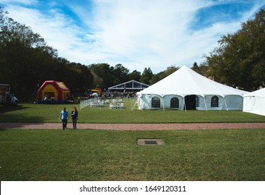 Williamsburg, VA / USA - Oct 19, 2019: Alumni Gather On The Sunken Gardens At William And Mary Old Campus To Celebrate Homecoming Weekend. Tents And Bouncy House Set Up For Fun. 