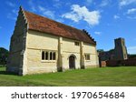 Willington Church, and Stables with blue sky and clouds.	
