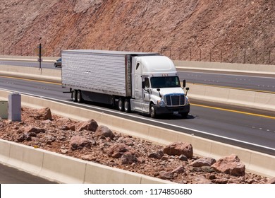 Willow Beach, Arizona, United States - August 18, 2018: Shot of a tractor-trailer truck driving on an interstate. 