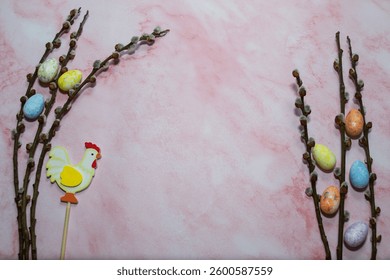 Willow branches with Easter eggs on a light pink background