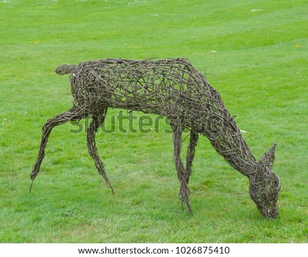 Willow Sculpture of a Deer in a Country Cottage Garden  in Rural Devon, England, UK