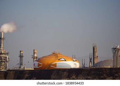 Wilmington, California USA - October 15, 2020: Smilin' Jack, World's Largest Jack O'lantern, Painted Each Halloween On A Refinery Storage Tank, Wears A Mask During Covid 19 Epidemic, Los Angeles