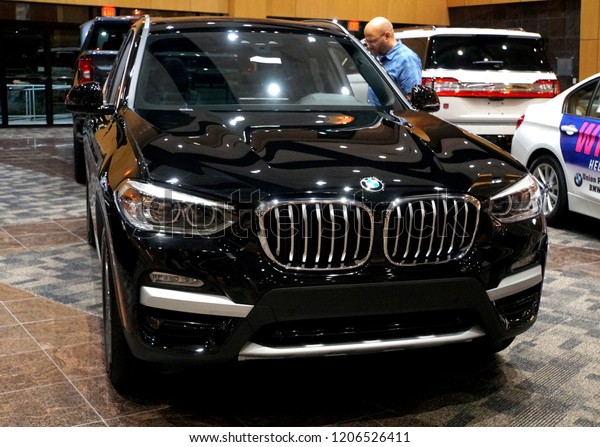 Wilmington,\
Delaware, U.S.A - October 5, 2018 - A customer reviewing the brand\
new 2019 BMW X3 SUV in black metallic color\
