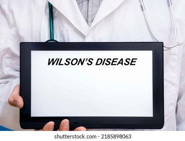 Wilson Disease.  Doctor with rare or orphan disease text on tablet screen Wilson%E2%80%99s Disease
