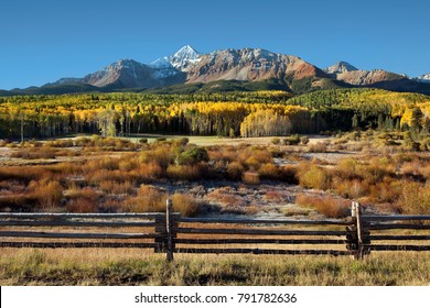 Wilson Peak In The Colorado Rockies Near Telluride With Yellow And Green Aspens And Rail Fence Just After Sunrise