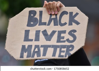 Wiltshire, UK. June 6 2020. A Black Lives Matter Protest Sign Being Held High By A Protester At An Anti-racism Rally In The UK As Demonstrators March In Solidarity With US Protesters