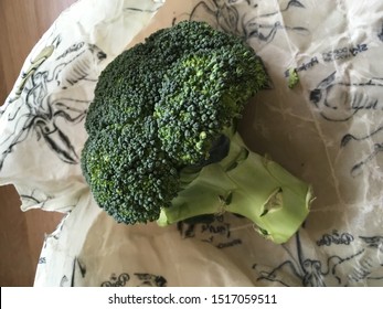 Wiltshire / UK - Sep28, 2019:  A Broccoli Piece About To Be Wrapped Up In An Environmentally Friendly Beeswax Food Wrap Designed By Sky Ocean Rescue.