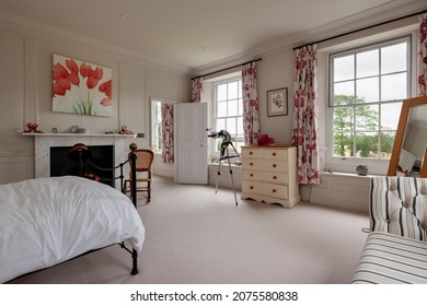 Wimbish, England - July 30 2019: Bedroom In English Period Home With Traditional Yet Sympathetically Modern Decor, Fireplace With Marble Surround And Georgian Style Multi Pane Windows