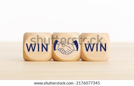 Win Win concept. Text and handshake Icon on wooden blocks. Copy space