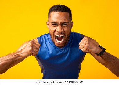 Win. Excited black man screaming, football fan celebrating victory and triumph of his team, supporting players - Powered by Shutterstock