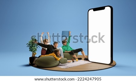 Win, goal. Astonished young people watching football match, sport show. Youth sitting on sofa in front of huge 3D model of cellphone screen. Concept of sport, leisure activities, betting, ad