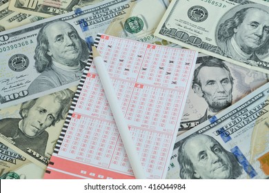 Win the lottery. Lottery ticket and pencil on dollar background