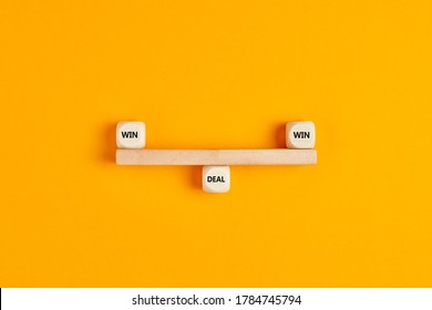 Win Win Situation In A Business Deal. Wooden Blocks Are Designed As A Seesaw On Balance With Win Win Text Written On Cubes. 