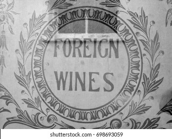 Winchester, Hampshire, England - August 14, 2017: Monochrome old foreign wines advertisement sign etched into public house window
