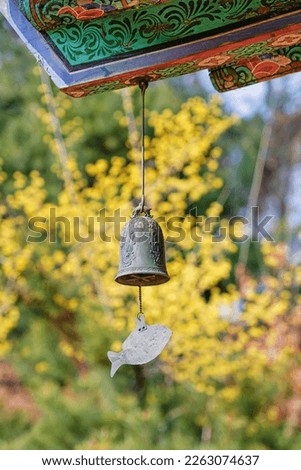 Wind bell at the end of eaves and Cornelius Flowers in Bongeunsa Temple, Seoul
