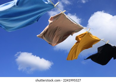 The wind blew clothes that had been dried in the sun and blown under the blue summer sky with cloud, symbolizing the work of housewives.