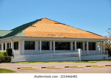 Wind Damaged House Roof With Missing Asphalt Shingles After Hurricane Ian In Florida. Repair Of Home Rooftop Concept