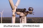 Wind energy farm turbine destroyed, old damaged by fire after a lightning strike. Windmill, energy production on hilly lanscape at autumn sunset - Aerial drone close up view