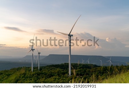 Wind energy. Wind power. Sustainable, renewable energy. Wind turbines generate electricity. Windmill farm on mountain with sunset sky. Green technology. Renewable resource. Sustainable development.