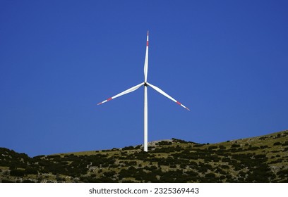 Wind energy tribunes that produces electricity with natural resources                         - Shutterstock ID 2325369443
