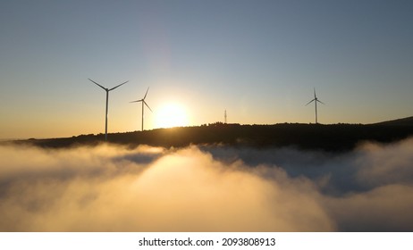 Wind Farm In The Fog At Sunrise. Aerial Photography