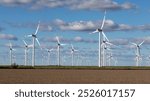 Wind farm with many wind turbines or wind wheels near Struckum in Nordfriesland, Schleswig-Holstein, Germany near the North Sea.