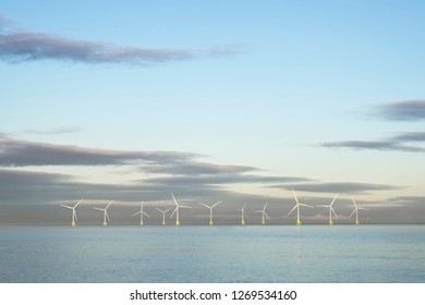 Wind Farm In North Sea Ocean Floating Turbines On Horizon Offshore At Aberdeen To Generate Energy And Electricity