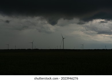 A wind farm from several wind turbines in a thunderstorm. Thunder Sky.