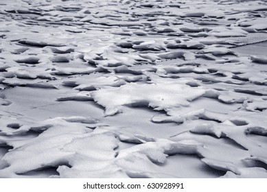 Wind form ice texture on winter mountain snow surface