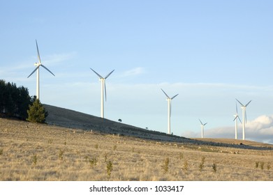 Wind generators line the hilltops on a modern wind farm.