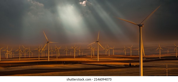 Wind Generators In Sherman County Oregon Wheat Country Are Shown Against A Dark Sky With Sun Rays.    Located A Few Miles South Of The Columbia River Gorge.