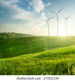 Wind Generators Turbines On Sunset Summer Landscape