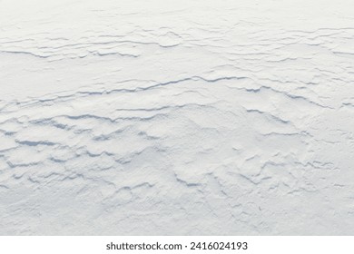 Wind has made patterns on snow surface.