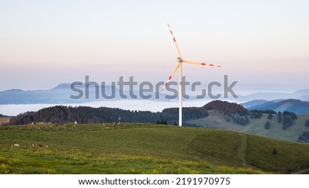 A wind mill power plant on a mountain range early in the morning in Austria
